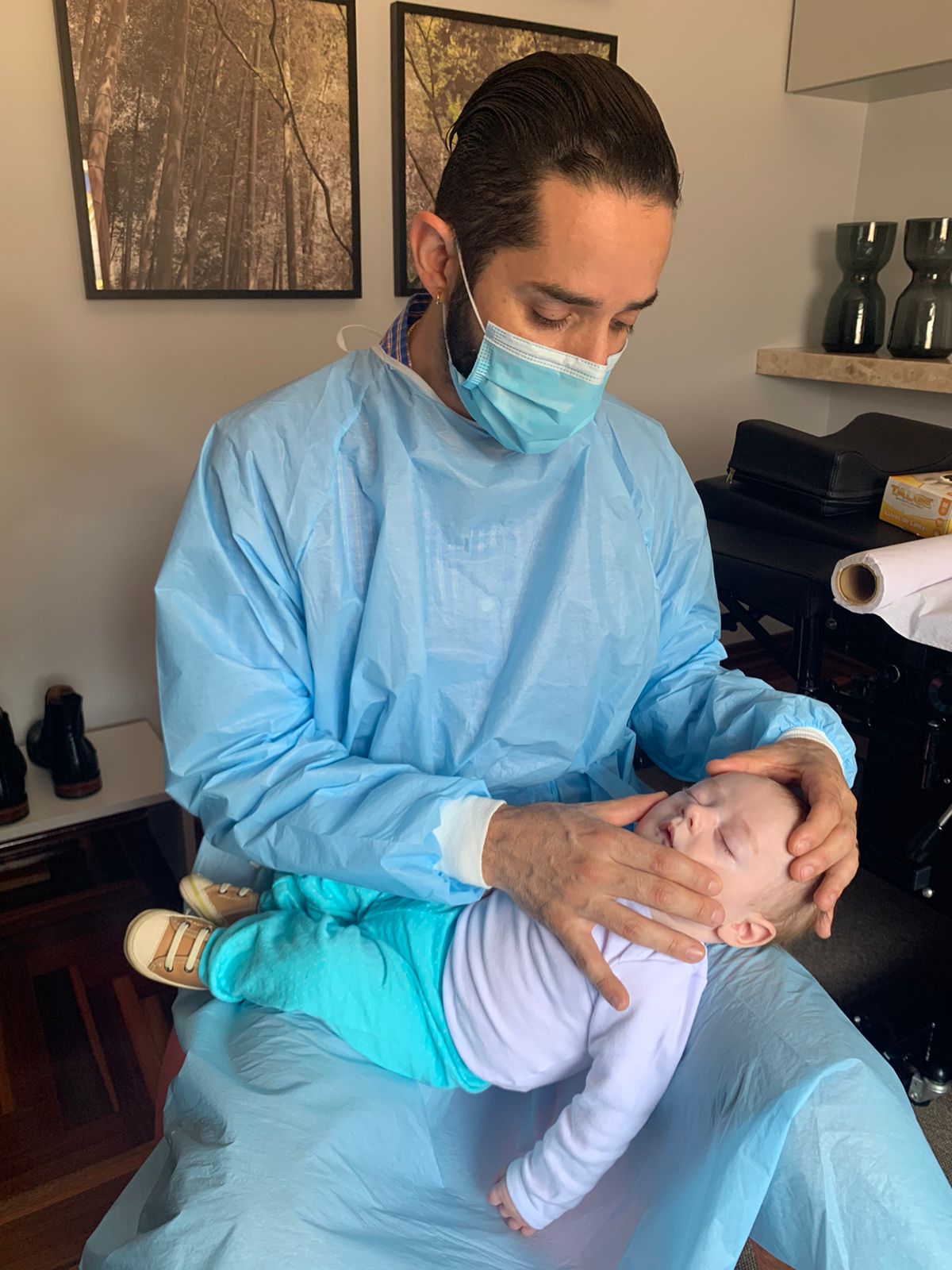 Dr. Eduardo Henrique atendendo bebê no consultório